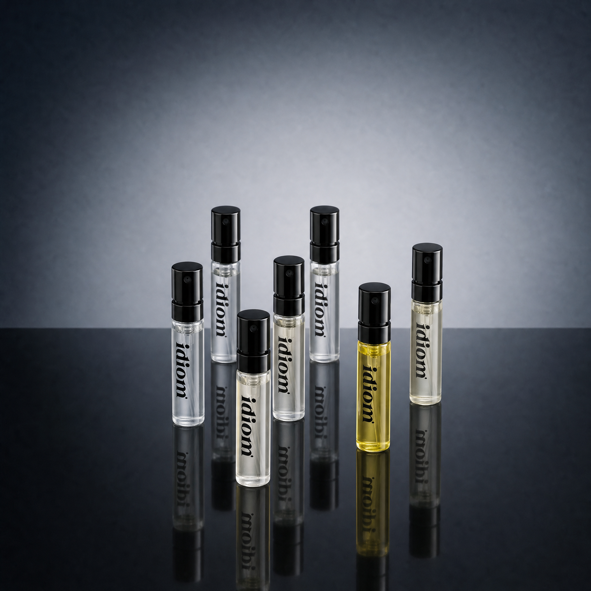 Generated_with_Kive.ai_-_Replace_the_perfume_box_and_bottle_with_the_set_of_slim_perfume_sample_vials_from_the_reference_image._Keep_the_same_studio_background__blue-gray_backdrop__ta.png